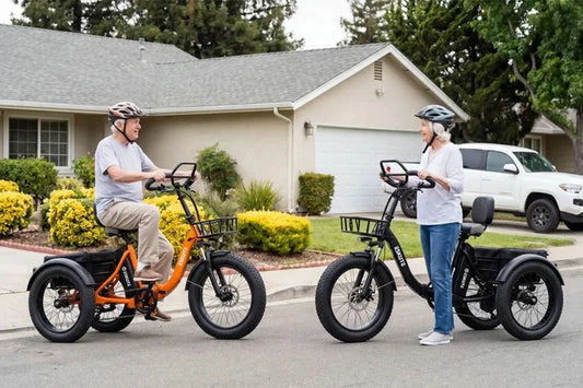 Elderly man and woman riding comfortable 3‑wheel electric tricycles on suburban street, stable e‑trike for seniors leisure riding